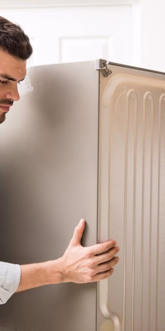 young-man-working-as-electrician-exposing-back-fridge-check-repair-it_662251-2712 Refrigerator and Freezer Disposal: How to Do It the Right Way